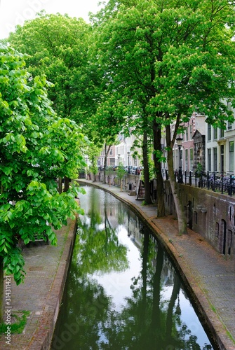 Beautiful canal view with trees on both sides in Utrecht, Netherlands