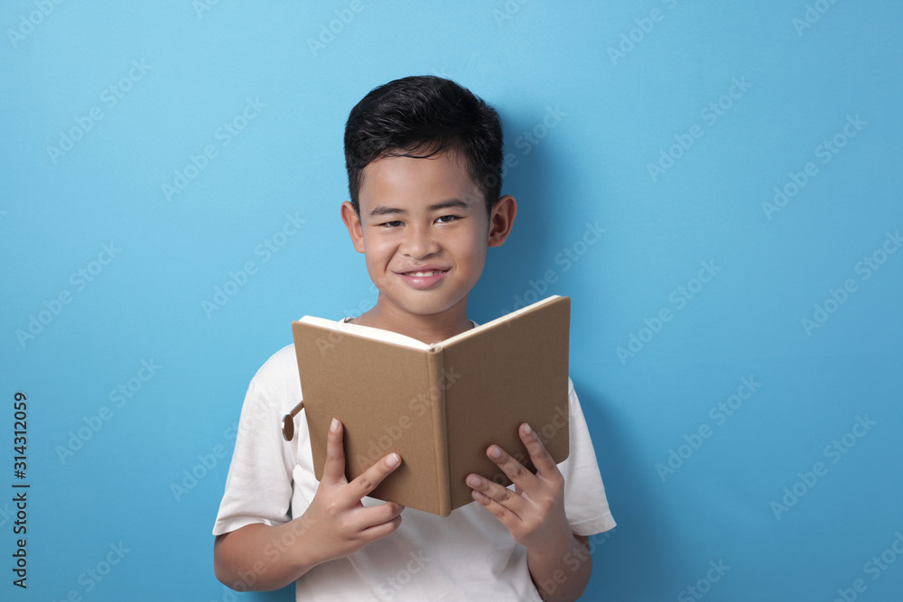 Asian boy smiling happily when reading a book Asian boy smiling happily when reading a book