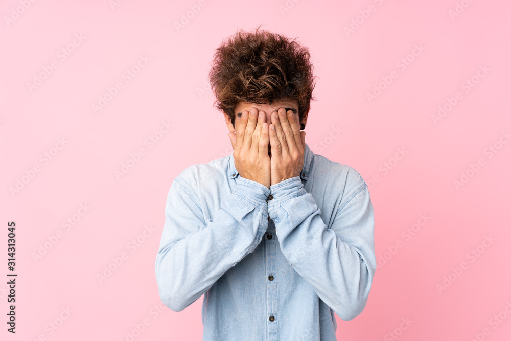 Young caucasian man with jean shirt over isolated pink background with tired and sick expression Young caucasian man with jean shirt over isolated pink background with tired and sick expression