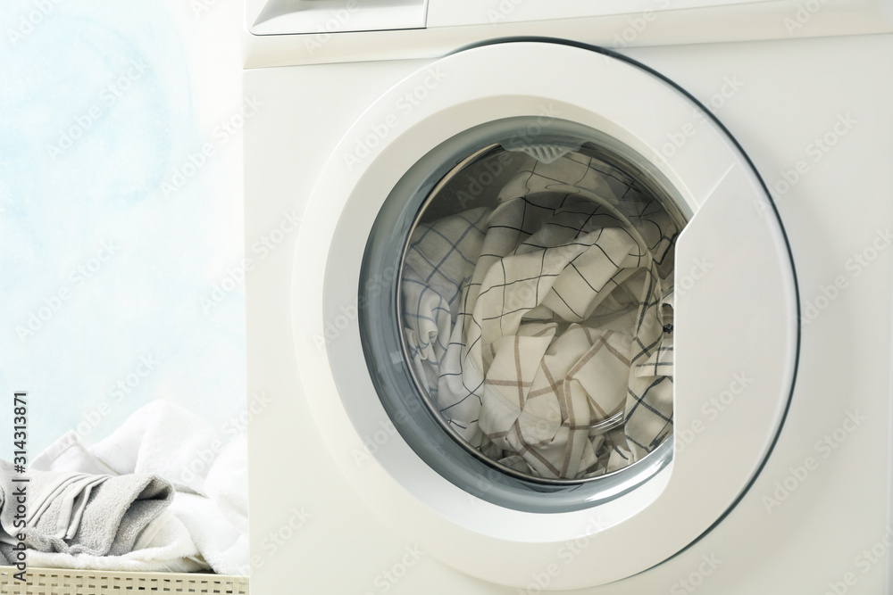 Laundry in a washing machine and in basket, close up Laundry in a washing machine and in basket, close up