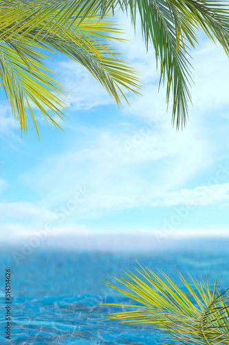 of sun light and leaf palm. Golden sand beach close-up, sea water, blue sky. Copy space, summer vacation concept