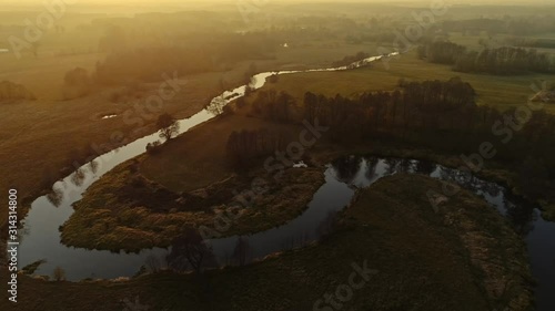 Scenic video of Polish river Wkra at sunset, almost fantasy scenery. Drone, aerial shot. Cinematic grading. photo