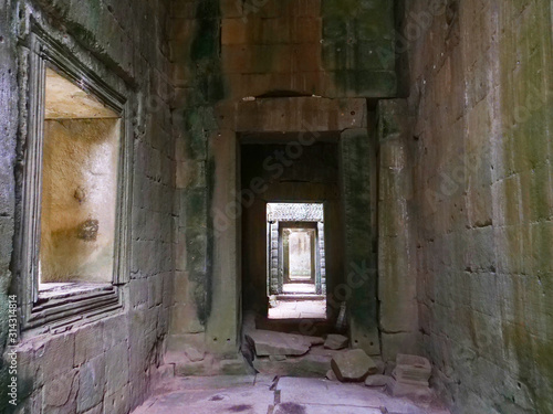 Demolished stone rock door frame at Preah Khan temple Angkor Wat complex  Siem Reap Cambodia. A popular tourist attraction nestled among rainforest.