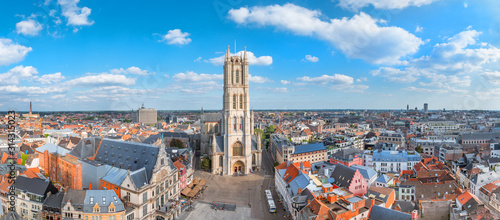 Aerial panorama of Saint Bavo cathedral and Gent cityscape from the Belfry of Ghent on a sunny day. Beautiful architecture and landmark of the medieval city of Gent in Belgium on summer.