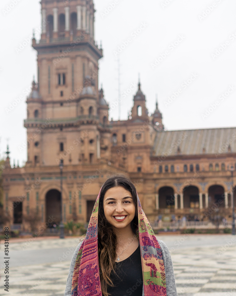 Woman smiling and standing in front of a historical building 