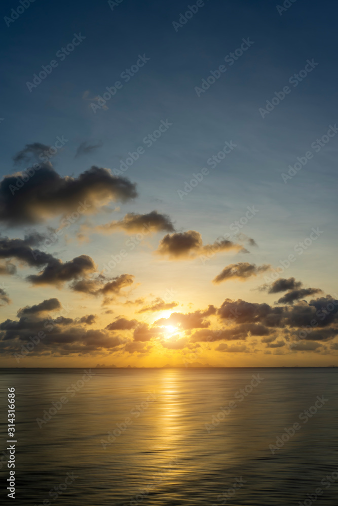 Fototapeta premium Sunset sky at the lake with dark clouds.