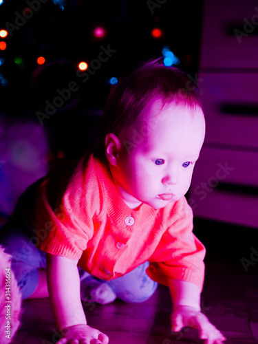 Baby with toys on the background of the Christmas tree