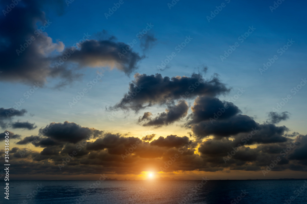 Fototapeta premium Sunset sky at the lake with dark clouds.