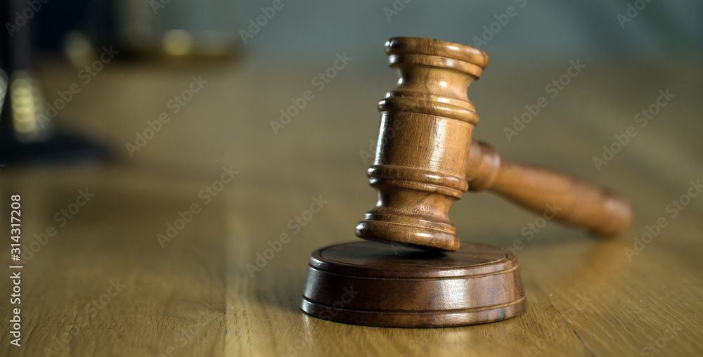 Symbol of law and justice on wooden table in lawyer office Symbol of law and justice on wooden table in lawyer office