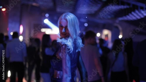 Attractive Dancing Blonde In The Club, Neon Light, Motion Effects. photo