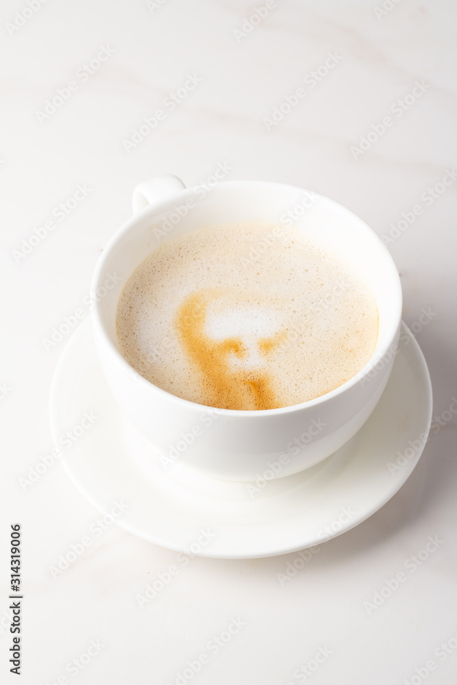 cappuccino coffee in a white mug on a white background cappuccino coffee in a white mug on a white background