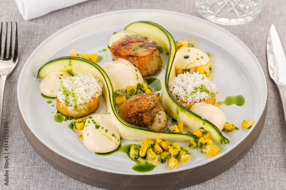 Sea scallops with zucchini and canned corn, with sauce and souffle