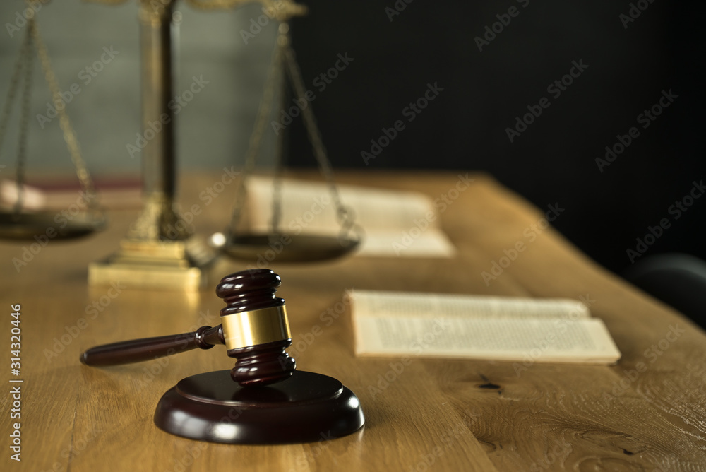 Symbol of law and justice on wooden table in lawyer office Symbol of law and justice on wooden table in lawyer office