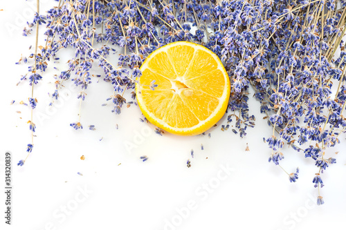 Fresh blue lavender with big lemon slice on white isolated background