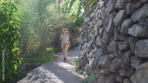 Young Woman Visiting Old Mountainous Village Misfat al Abriyeen near Nizwa, Oman photo