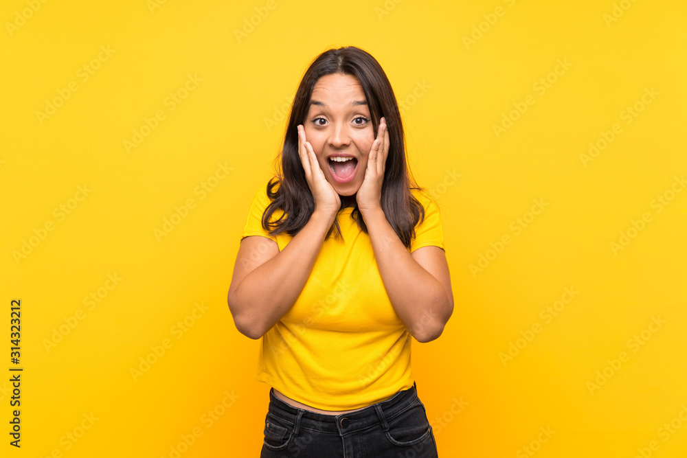 Young brunette girl over isolated background with surprise and shocked facial expression Young brunette girl over isolated background with surprise and shocked facial expression