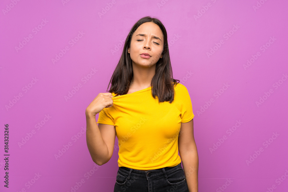 Young brunette girl over isolated background with tired and sick expression Young brunette girl over isolated background with tired and sick expression