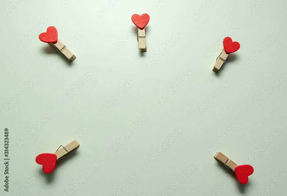 White background. A small wooden clothespin with a red heart. Love. Valentine's day. Happy. White background. A small wooden clothespin with a red heart. Love. Valentine's day. Happy.