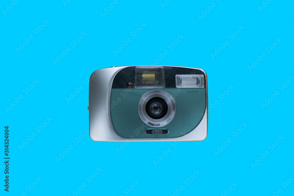 compact digital camera on blue background