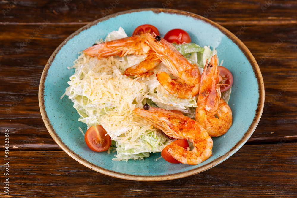 Salad with shrimp, grated parmesan cheese and salad leaves