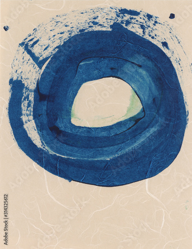 Blue ink circle enso on asian textural natural fiber paper.  photo