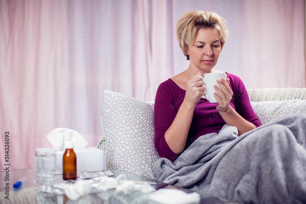 Woman got the flu and treated at home. People, healthcare and medicine concept Woman got the flu and treated at home. People, healthcare and medicine concept