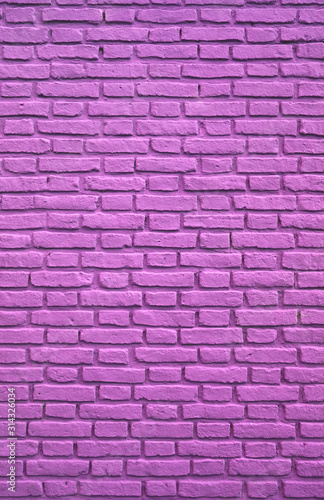 Vertical Image of Purple Pink Colored Aging Brick Wall