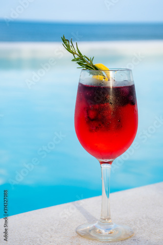 iced mixed berry cocktail against pool side