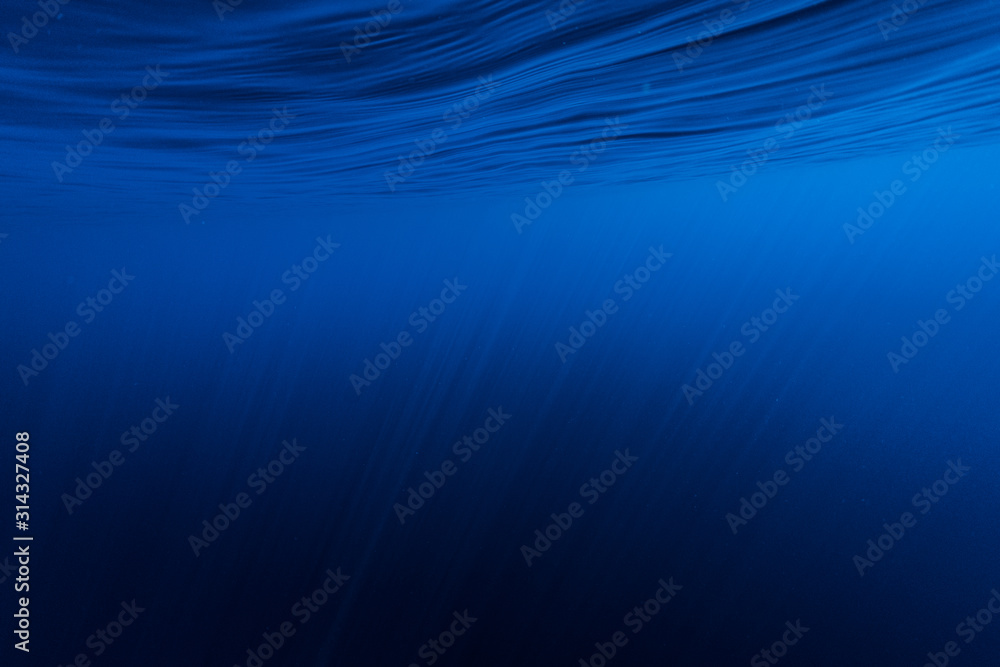 Calm smooth sea with sun rays penetrating into the depth Calm smooth sea with sun rays penetrating into the depth