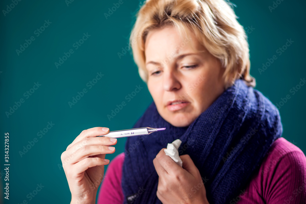 Fototapeta premium Woman got the flu and measuring temperature. People, healthcare and medicine concept