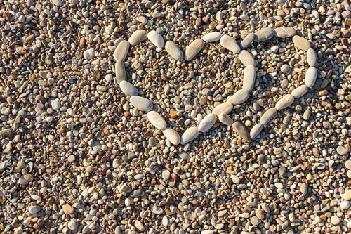 Two hearts laid out of pebbles on the beach. The concept of people who love each other. Valentine's day gift.