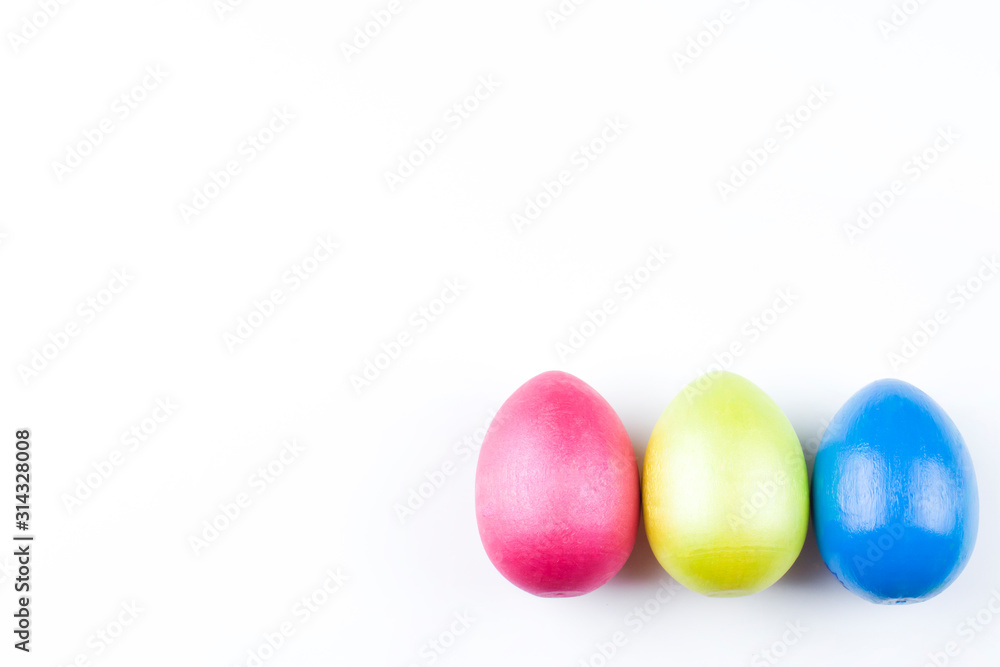 happy Easter, colored eggs in a basket and spring flowers on a white background, spring Orthodox Christian and Catholic holiday, banner with space for text