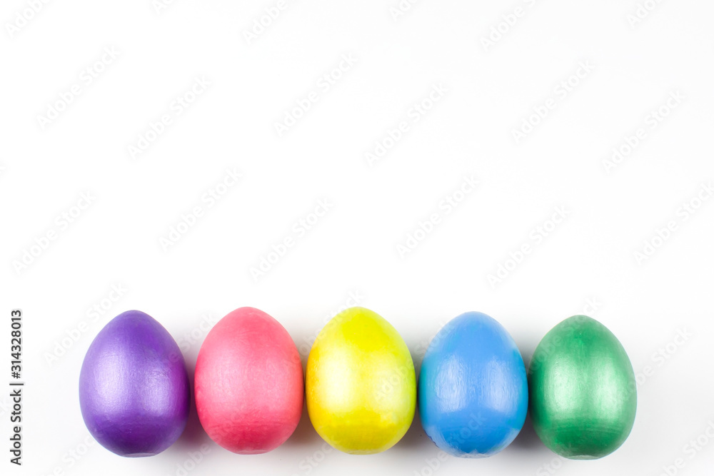 happy Easter, colored eggs in a basket and spring flowers on a white background, spring Orthodox Christian and Catholic holiday, banner with space for text