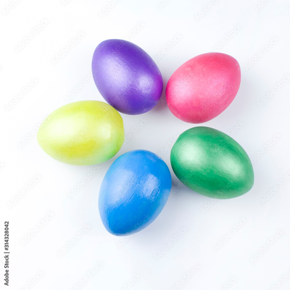 happy Easter, colored eggs in a basket and spring flowers on a white background, spring Orthodox Christian and Catholic holiday, banner with space for text happy Easter, colored eggs in a basket and spring flowers on a white background, spring Orthodox Christian and Catholic holiday, banner with space for text