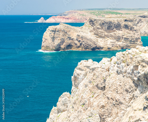 Portugal, Algarve, view of famous cliffs of Moher and wild Atlantic Ocean, Portuguese coastline close to Cape St. Vincent on a sunny and clear day with The blue Atlantic  in the background