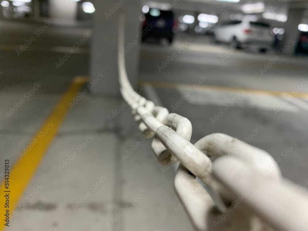 Naklejka premium Close up of plastic chain in parking lot