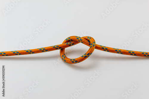 overhand knot orange rope example, white background, isolated photo