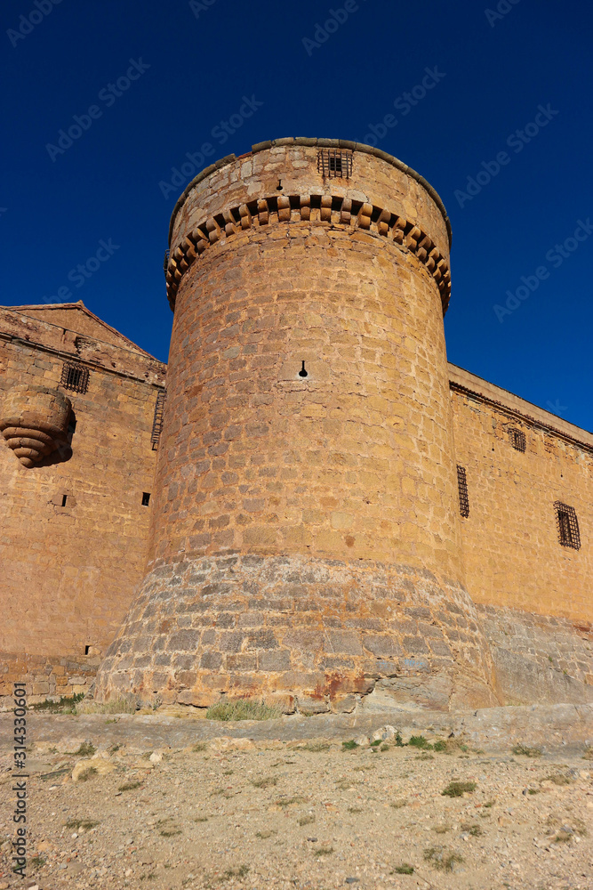 Towers of medieval spanish castle La Calahorra on the hill against azure winter sky