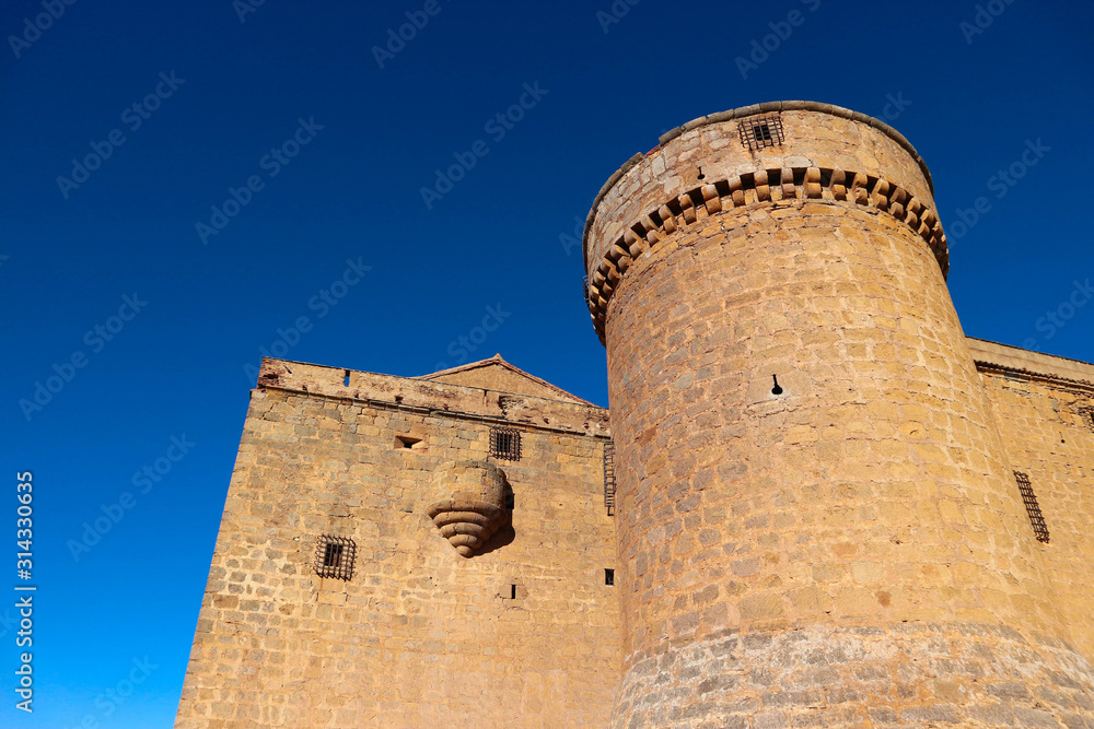 Towers of medieval spanish castle La Calahorra on the hill against azure winter sky Towers of medieval spanish castle La Calahorra on the hill against azure winter sky