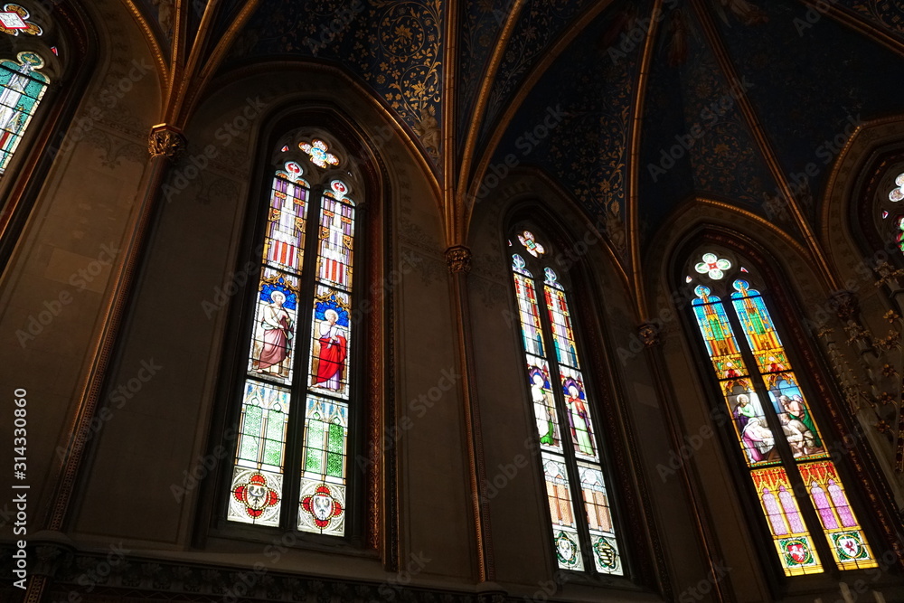 Stained glass windows of a private chapel in a a medieval castle. Three windows.
