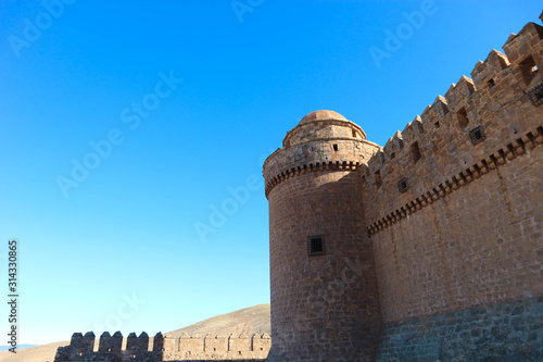 Tower and wall of medieval castle La Calahorra, Granada, Andalucia, Spain photo