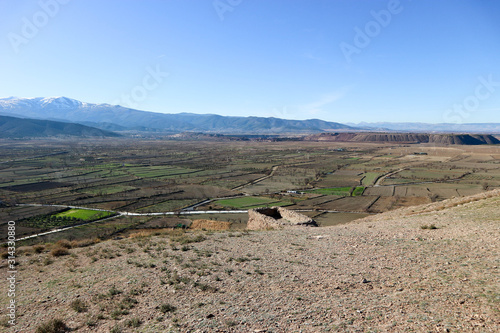 landscape with valley full of fields in sierra nevada mountains and blue sky