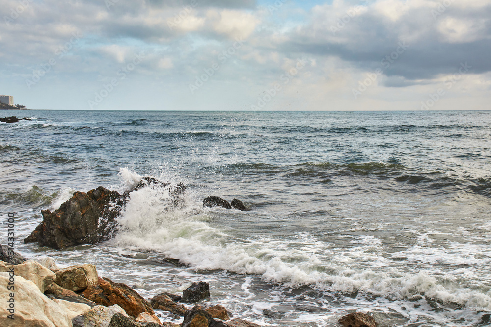 Strong waves in the sea hitting the rocks of the coast Strong waves in the sea hitting the rocks of the coast