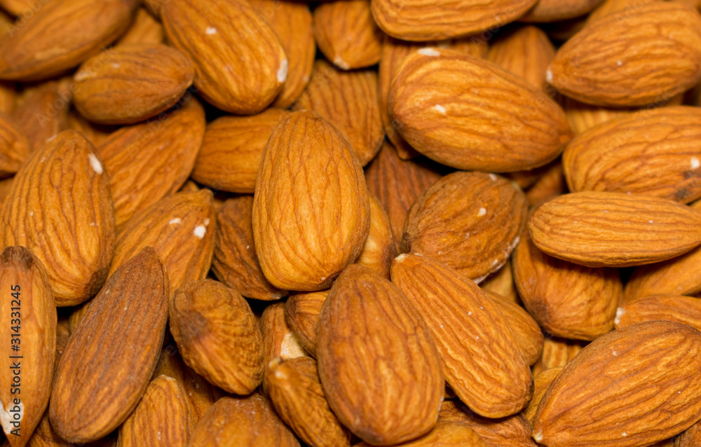 Fototapeta premium delicious almonds, peeled walnuts