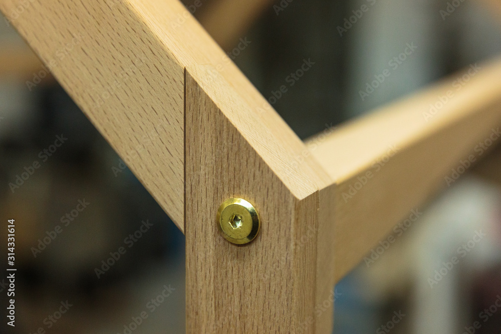 Detail of a furniture maker holding an example of his intricate Japanese joinery