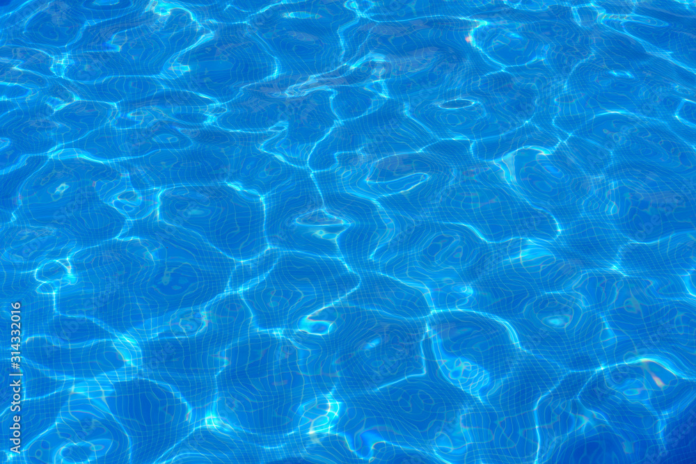Water surface with light reflections in a swimming pool as a background