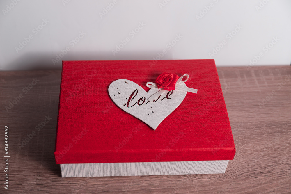 Gift box for the day of all lovers. Box with a heart and a flower on the lid