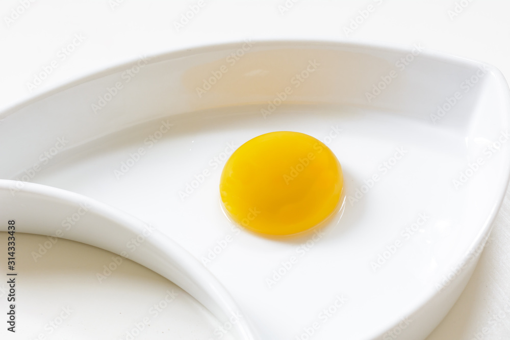 egg yolk on white plate egg yolk on white plate