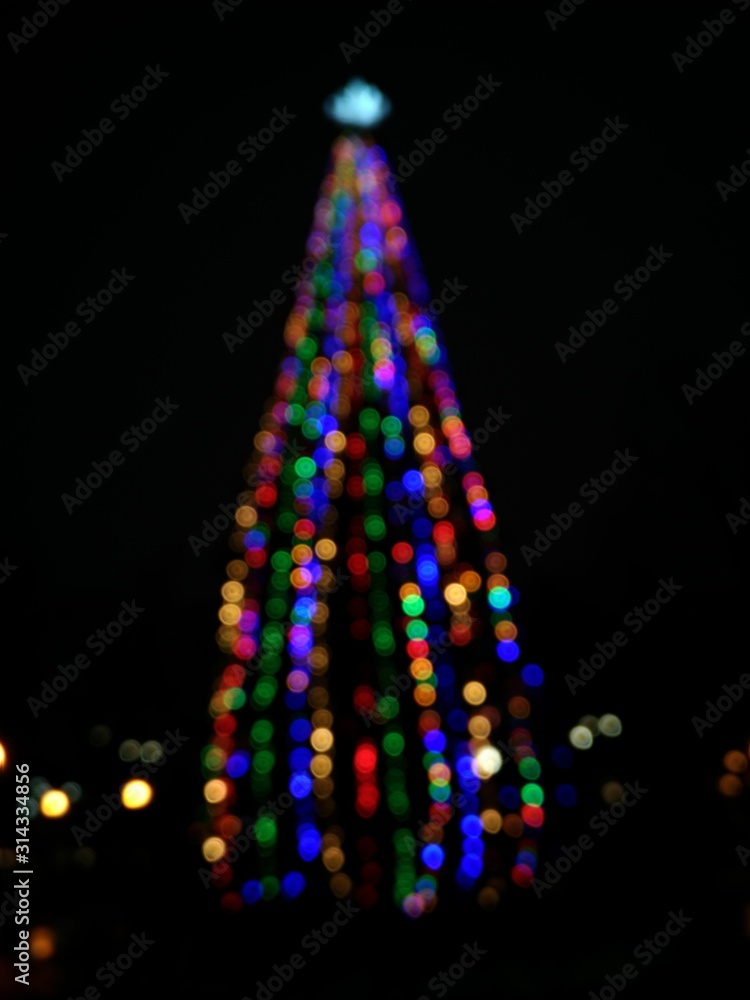 christmas tree on black background with lights, defocused, bokeh blur christmas tree on black background with lights, defocused, bokeh blur