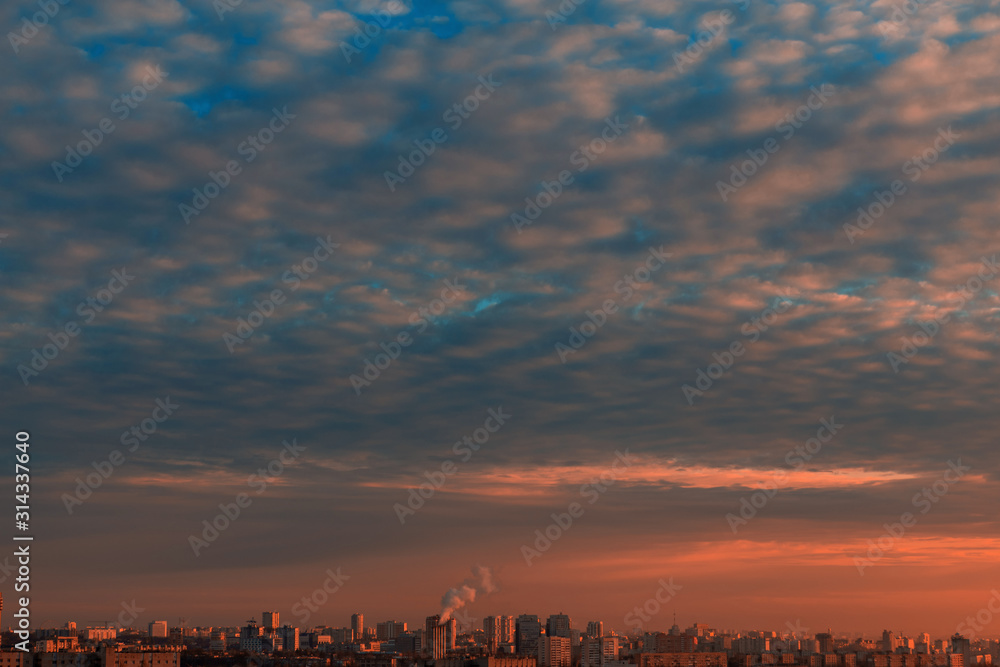Beautiful sky with clouds over the city at sunset